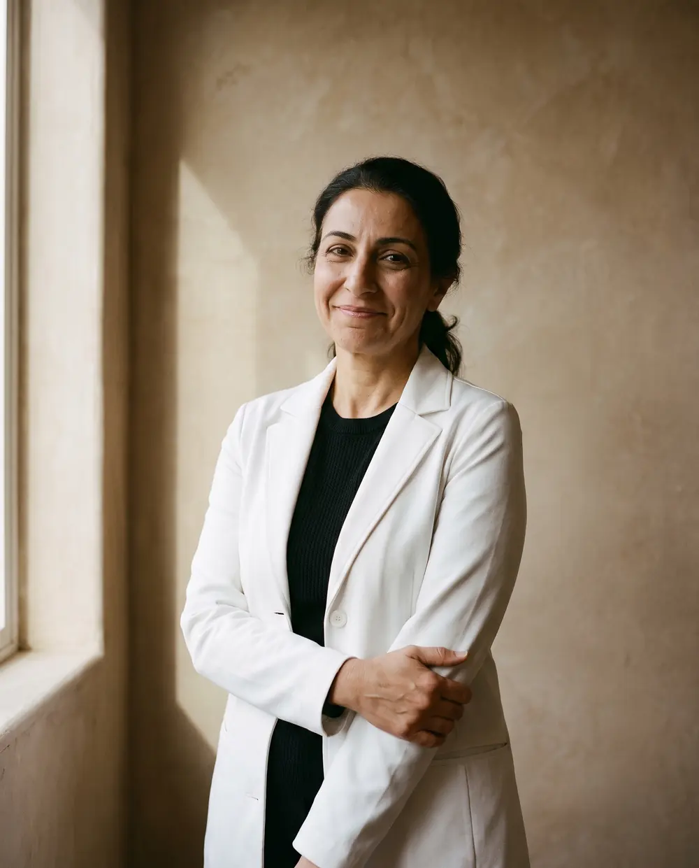 A smiling clinician at her desk