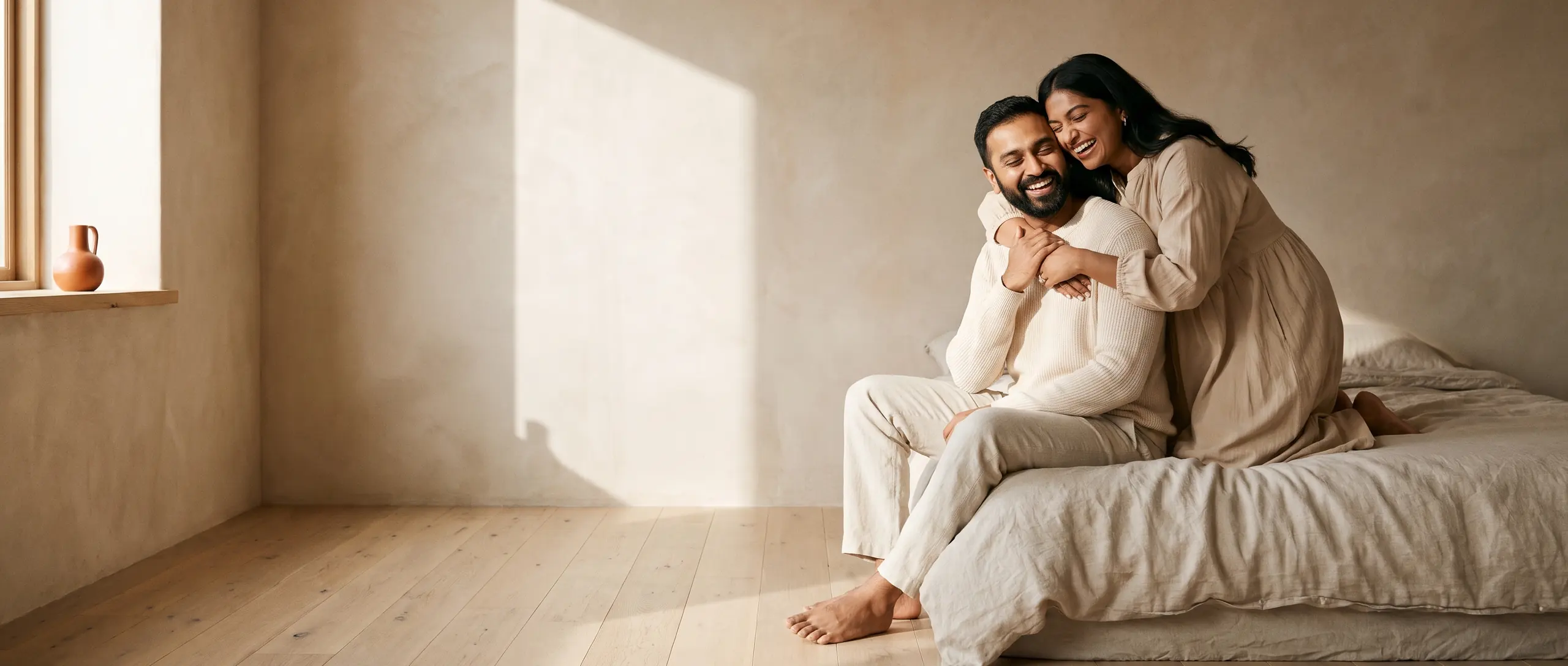 A couple laughing together on a slow Sunday morning